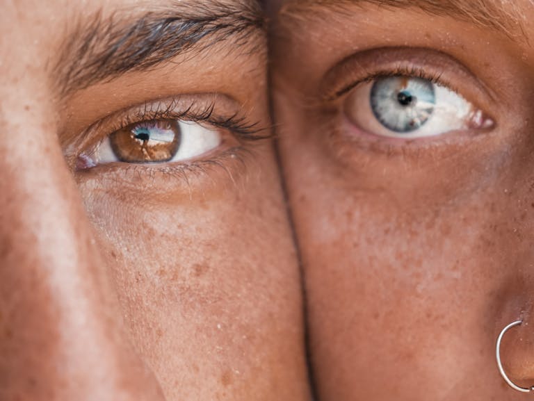 A detailed close-up showcasing a blue eye and a brown eye in contrast, emphasizing unique natural beauty.
